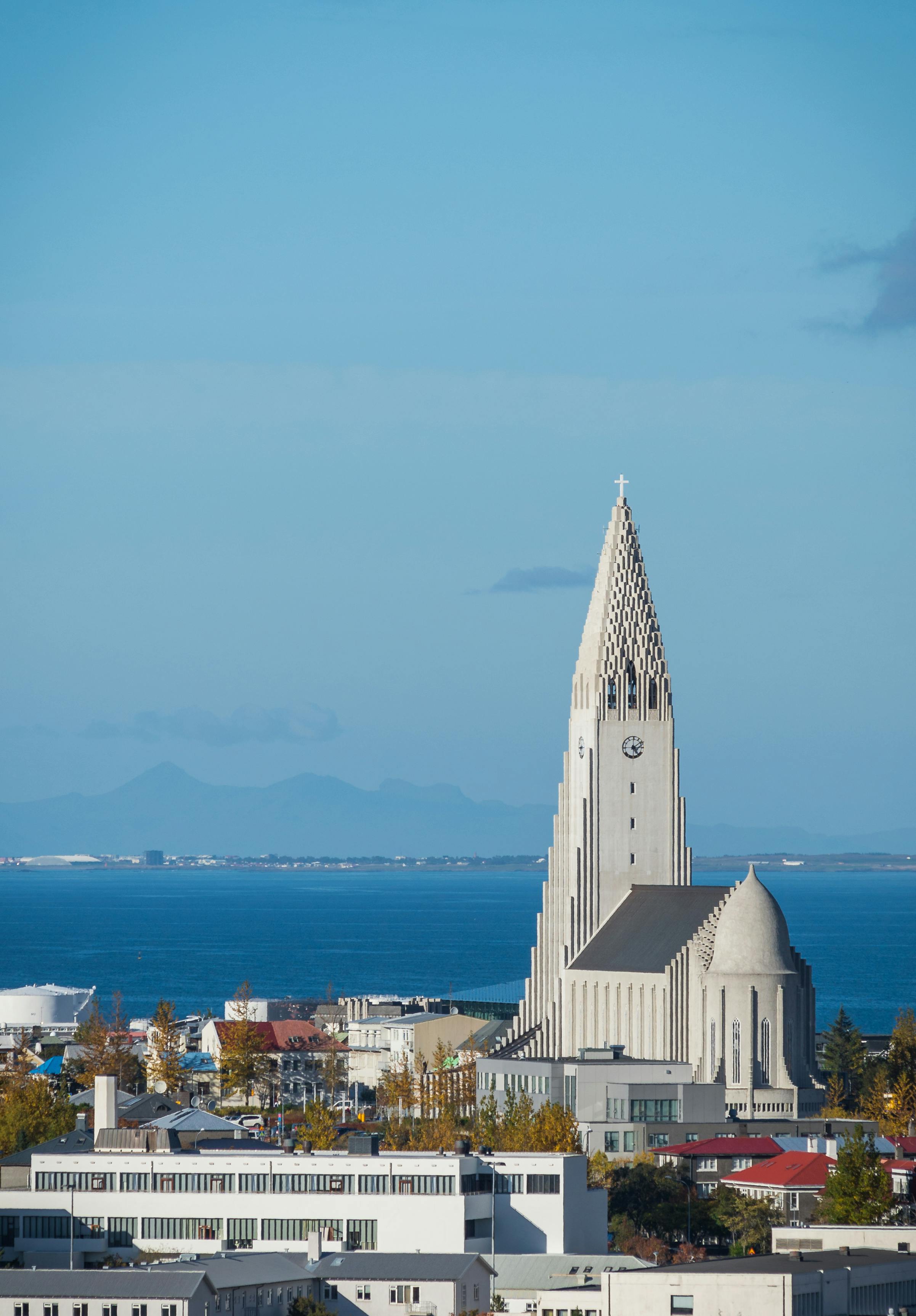 Photo of Reykjavik, Iceland, with Hallgrimskirkja Lutheran Church near ocean background